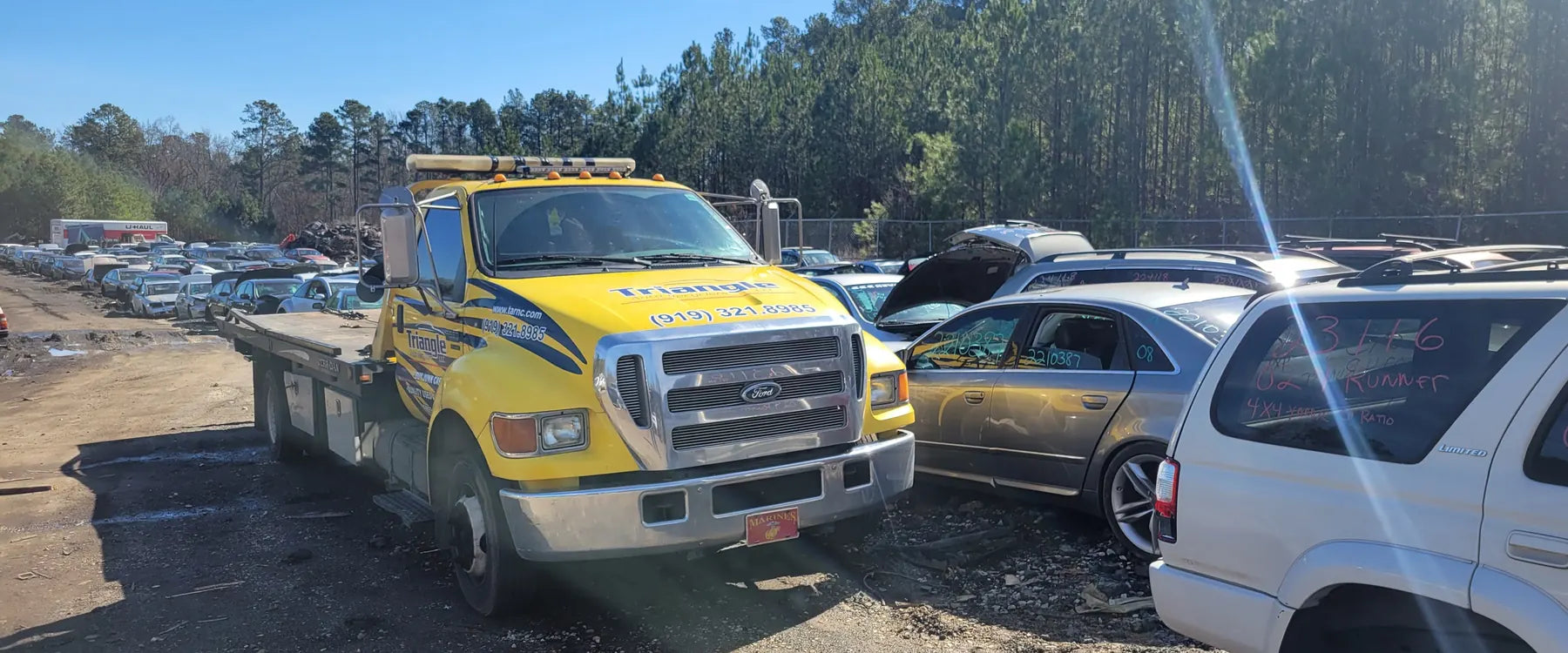 The Triangle Auto Recyclers tow truck in the yard